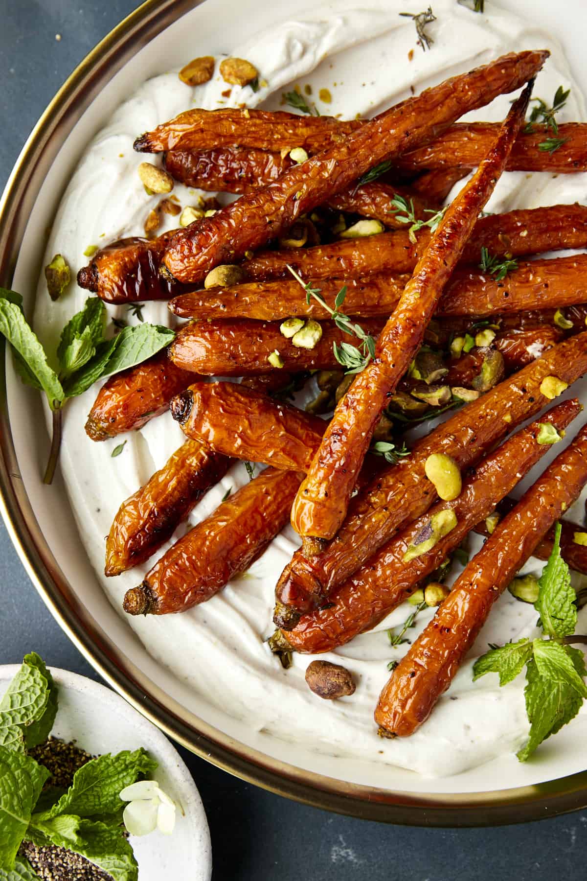 Oven roasted carrots with tahini dressing topped with mint and pistachios. 