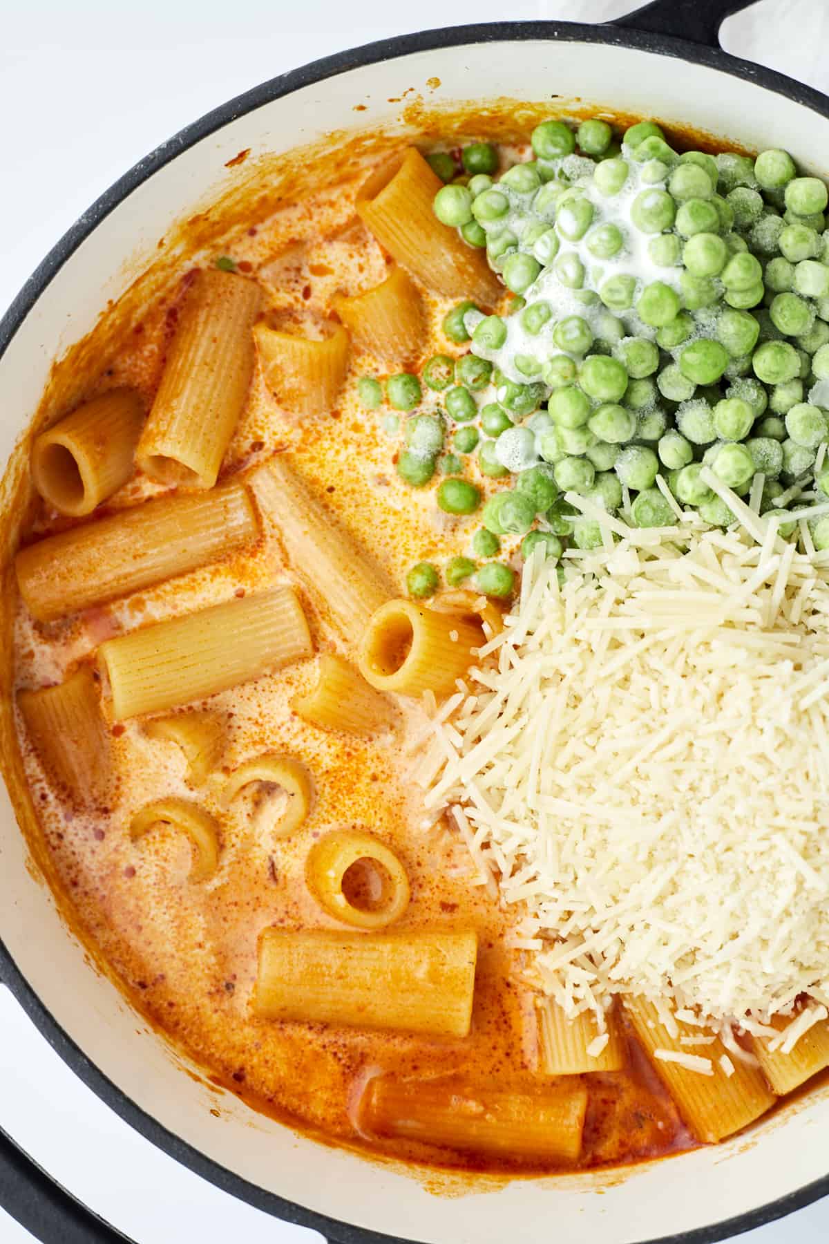 One Pot Spicy Rigatoni of overhead of peas ad parmesan cheese
