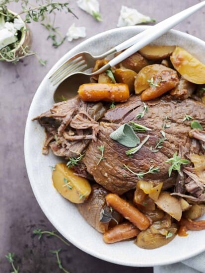 slow cooker beef pot roast with carrots and potatoes.