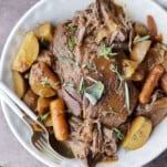 Slow cooker beef pot roast with potatoes and carrots.
