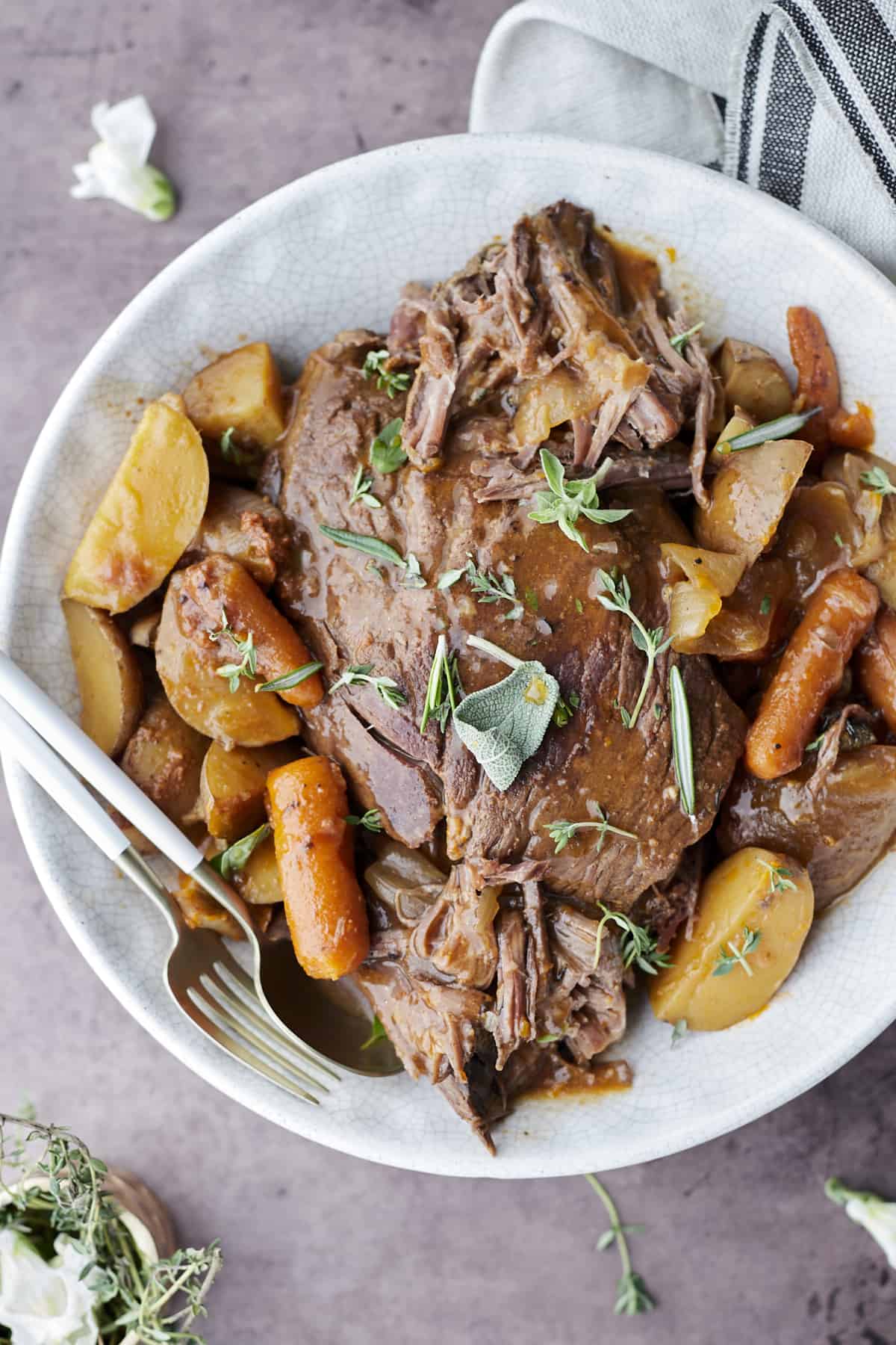 Slow cooker beef pot roast with potatoes and carrots.