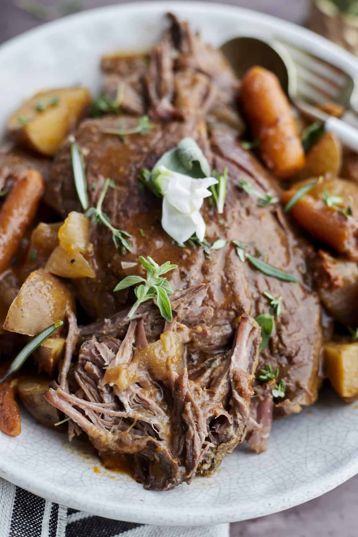 slow cooker beef pot roast with potatoes and carrots. 