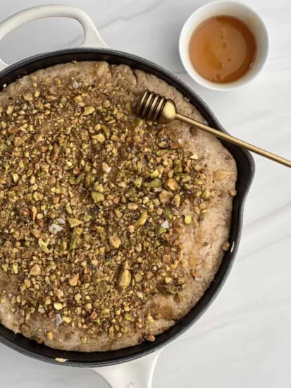 overhead image of a baklava skillet pancake in a cast iron skillet
