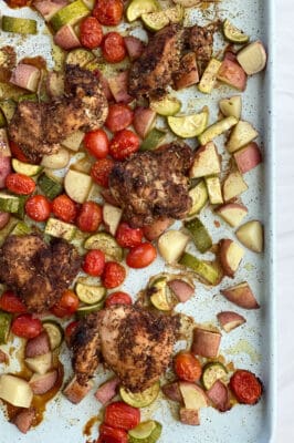 overhead image of sheet pan chicken thighs and veggies
