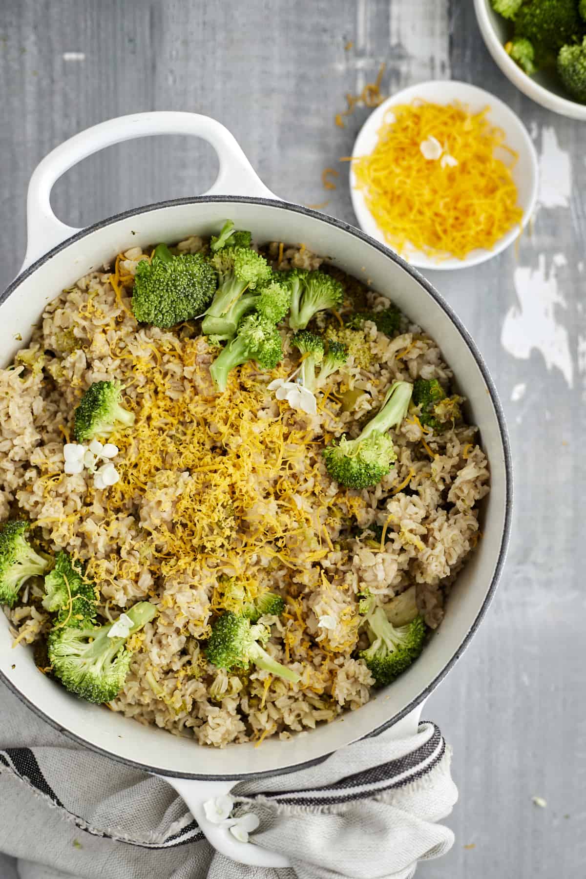 overhead image of a pot full of chicken and broccoli rice topped with cheese