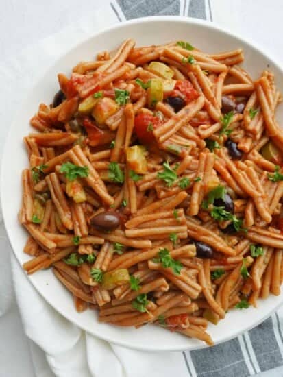 a plate of one pot pasta puttanesca with whole wheat pasta