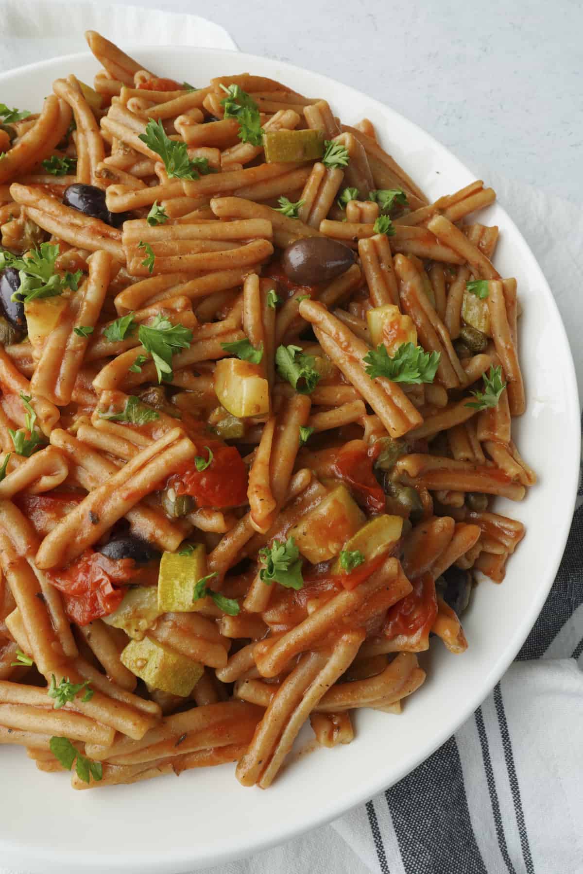 o bowl of pasta puttanesca with whole wheat pasta