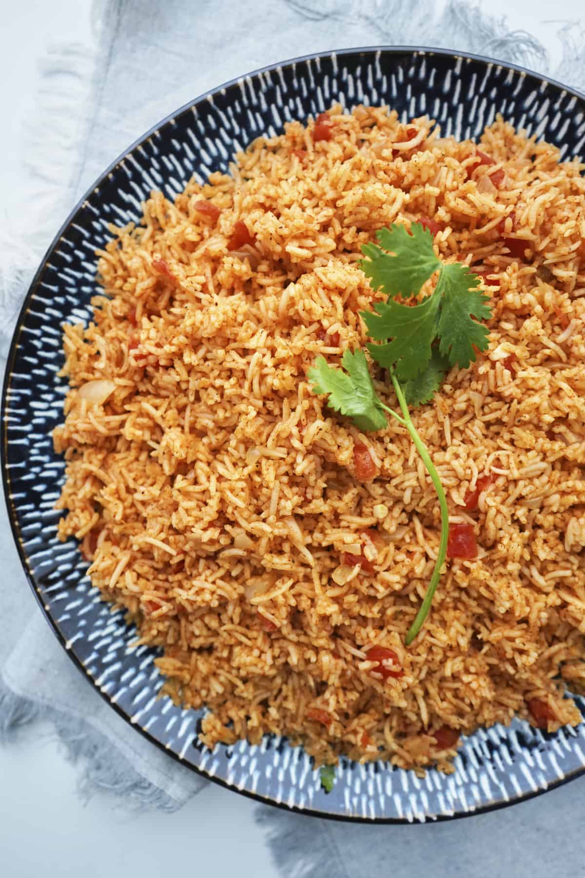 large platter of spanish rice with fresh cilantro