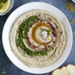 Baba ganoush on a plate with olive oil and parsley