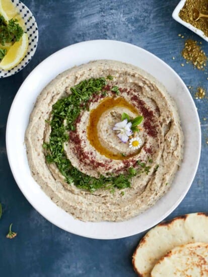 Baba ganoush on a plate with olive oil and parsley
