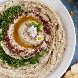 Fire Roasted Baba Ganoush on a plate with olive oil and parsley