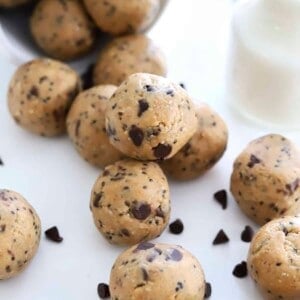 peanut butter energy balls spilling out of a cup with chocolate chips