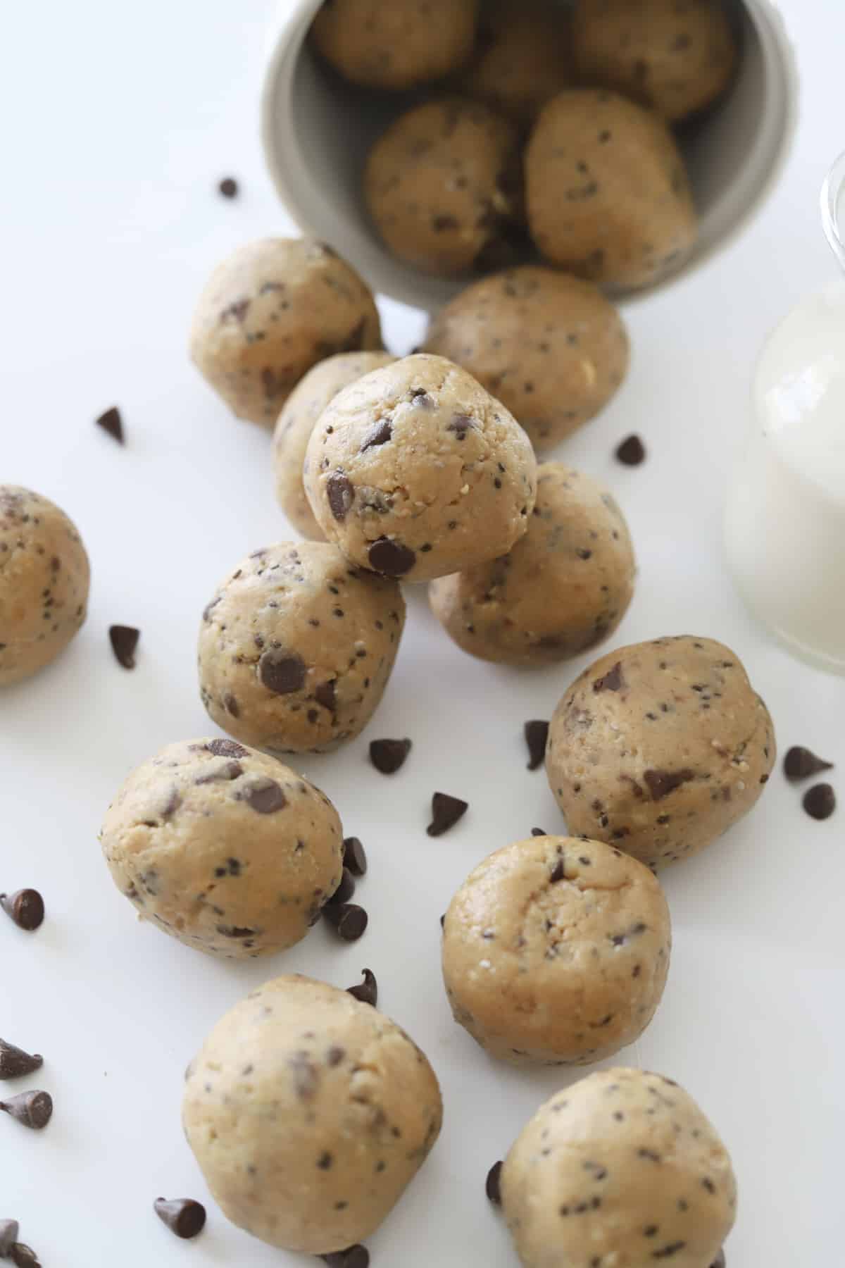 a cup shaking out peanut butter energy balls 