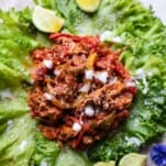 A serving of instant pot chicken fajita mix on a lettuce cup.
