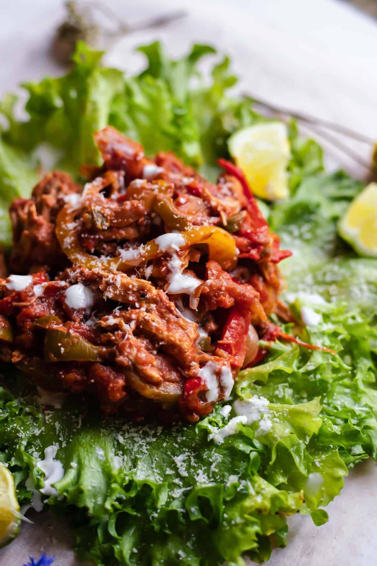 instant pot chicken fajita meat on lettuce leaves.