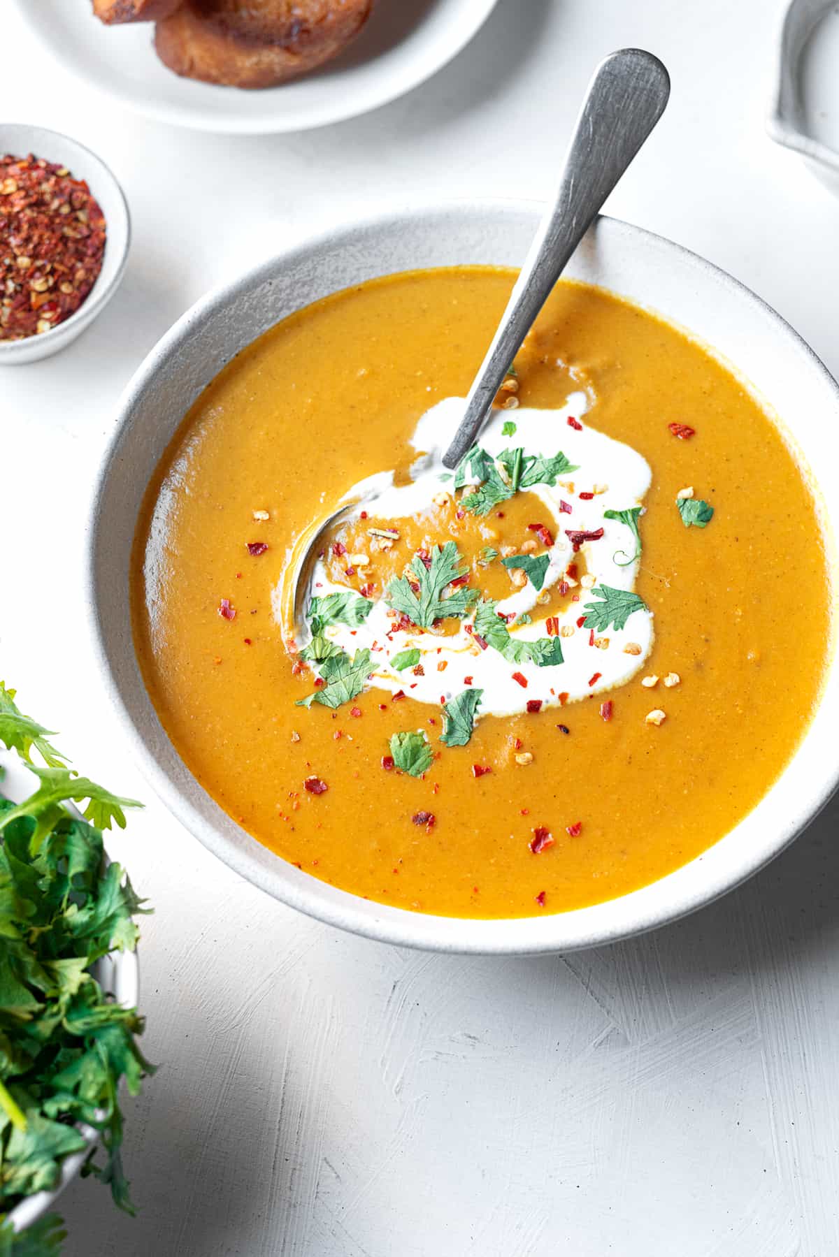 a bowl of creamy Egyptian lentil soup with a spoon sticking out 