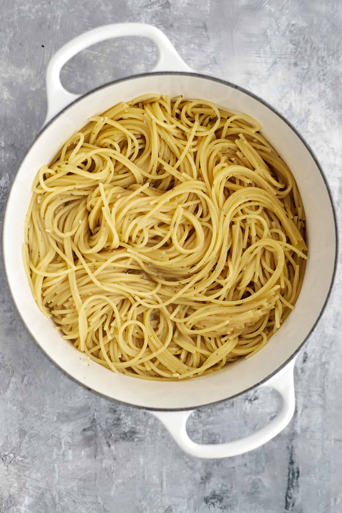 overhead image of cooked spaghetti noodles in broth