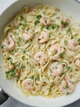 a bowl of creamy linguine shrimp alfredo