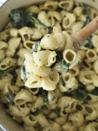 overhead of lemon garlic pasta on wooden spoon