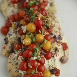 baked chicken topped with whipped feta and tomatoes
