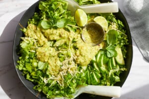 Green goddess salad topped with green goddess dressing.