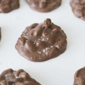 chocolate peanut slow cooker candy clusters topped with salt
