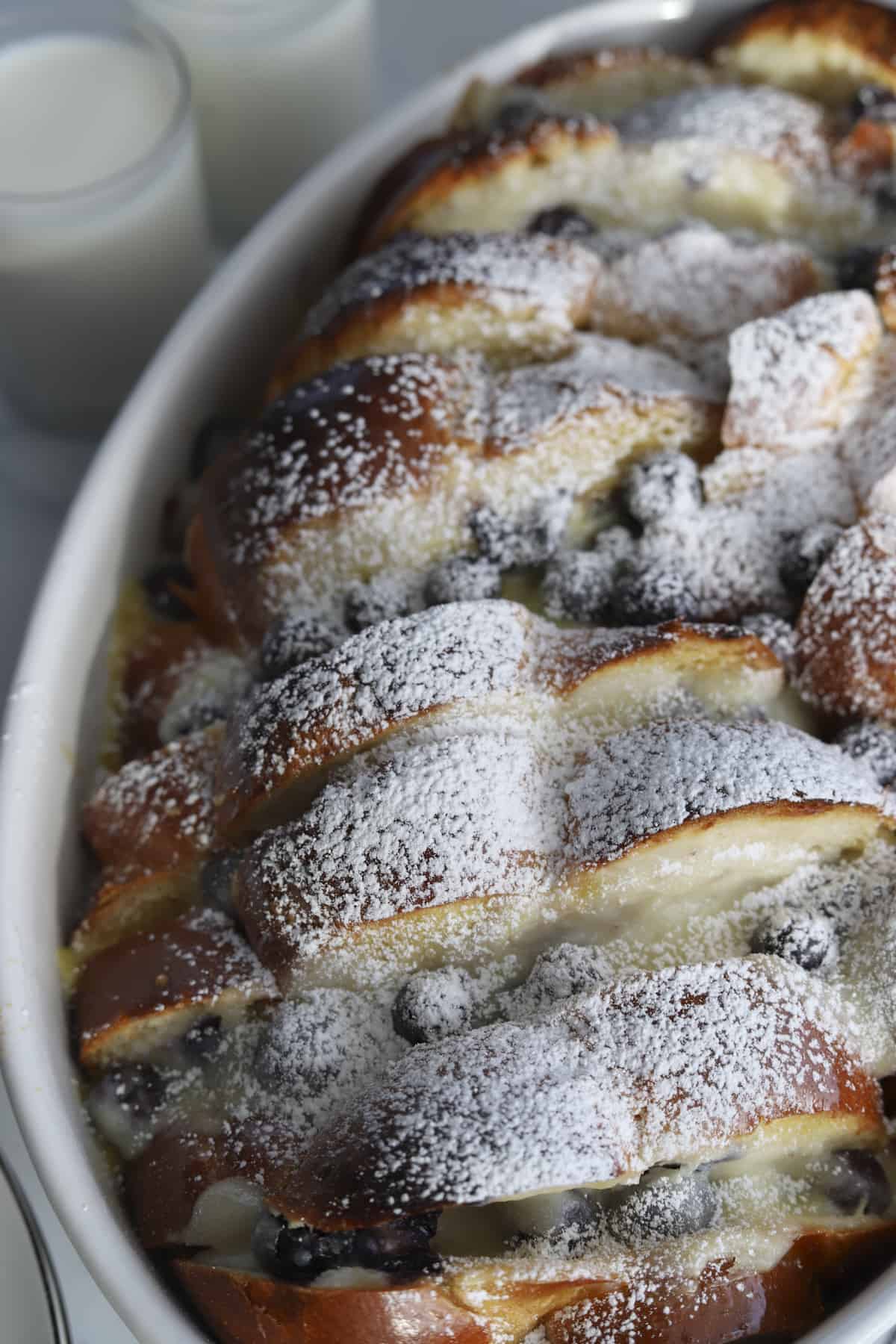 side view blueberry mascarpone french toast baking dish with powdered sugar