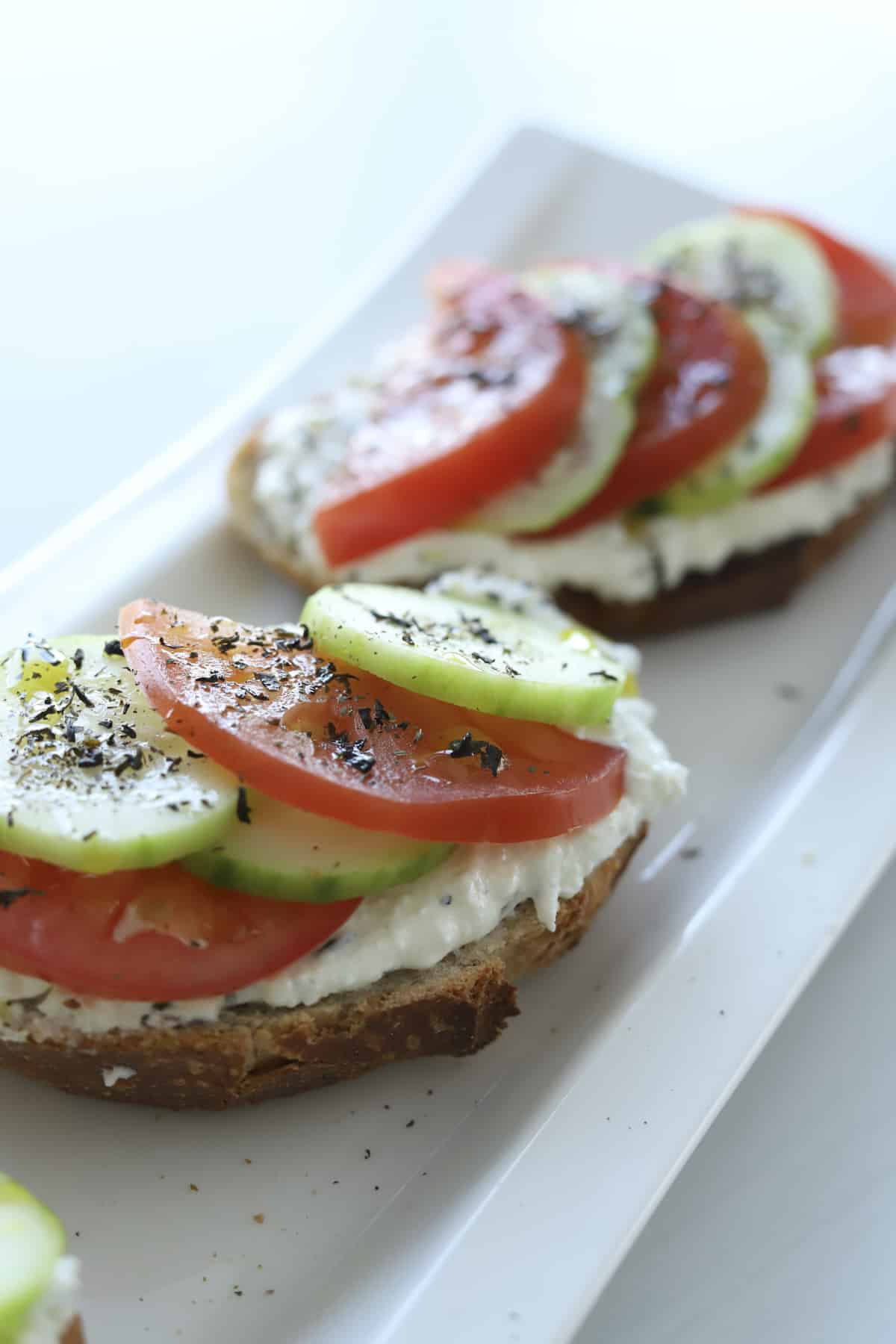 feta toast with tomatoes and cucumbers and dried mint