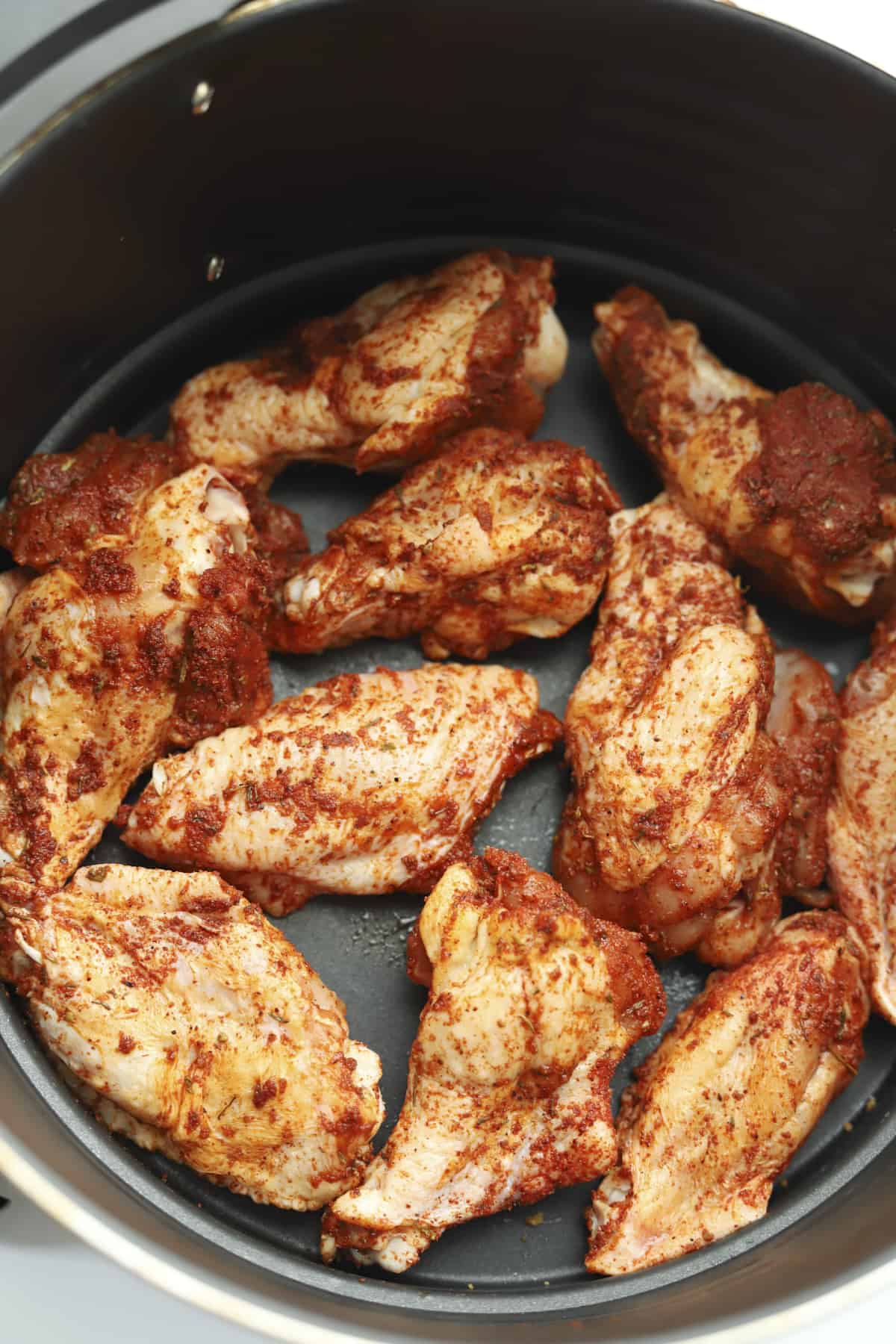 raw seasoned chicken wings in an air fryer