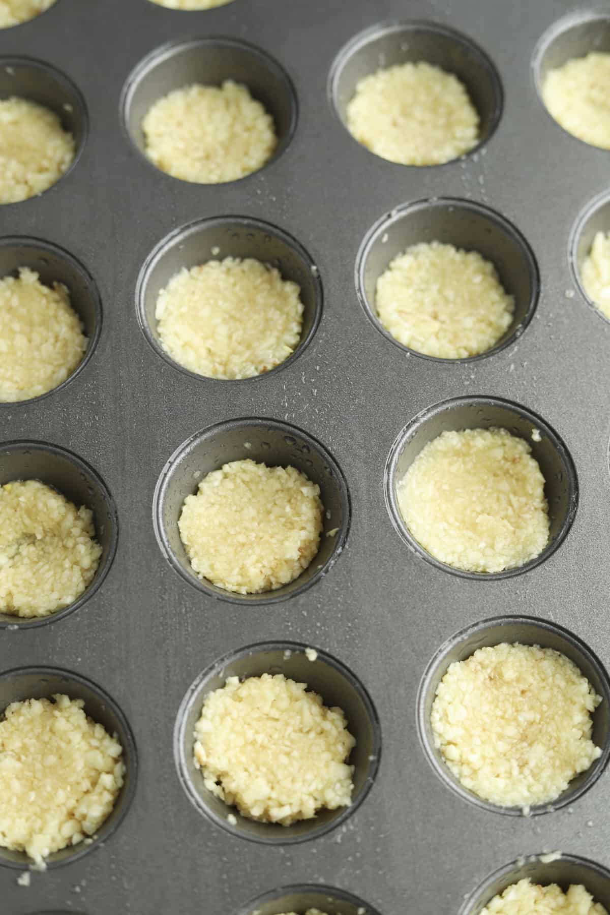 garlic in a mini muffin tin.