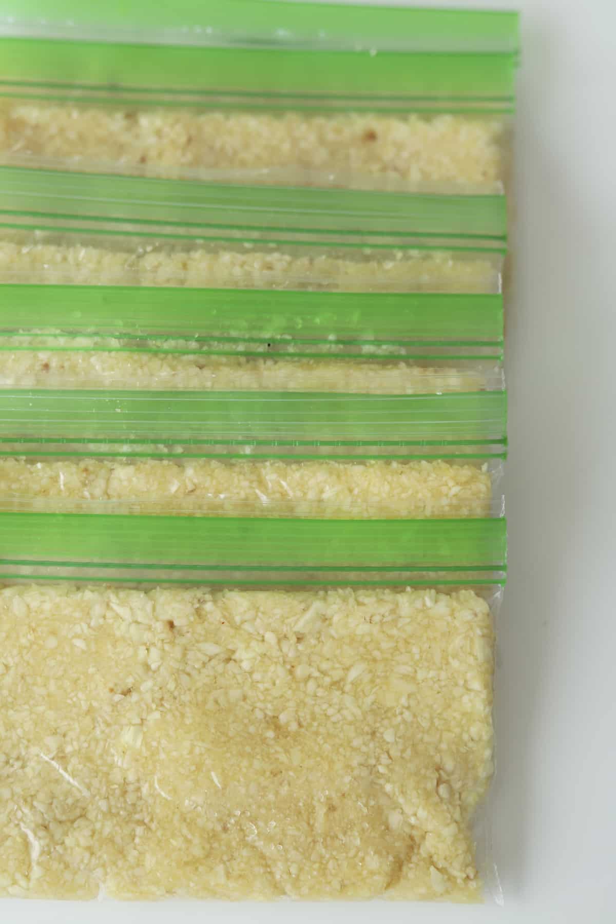 overhead of ground garlic in small ziploc bags