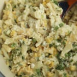 one pot elote pasta being stirred with a spoon