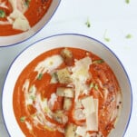 two bowls of roasted red pepper and cauliflower soup