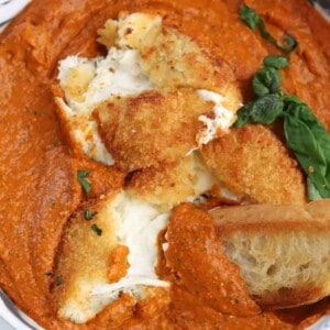 fried burrata with romesco sauce with bread dipped in