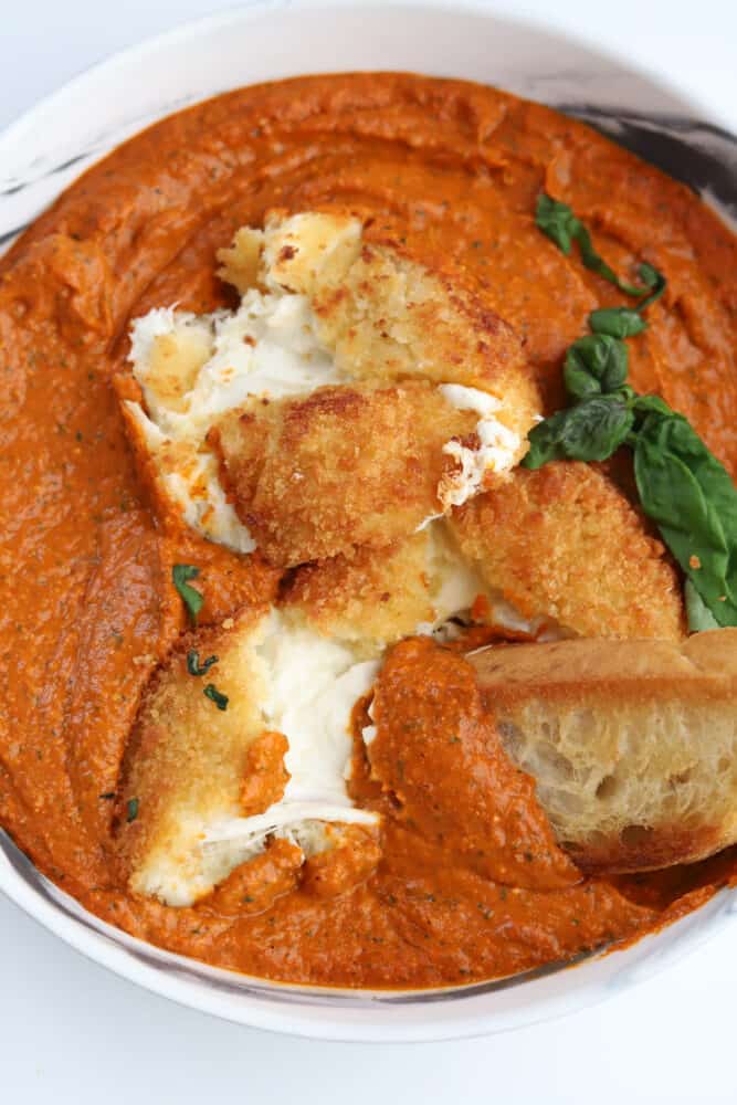 fried burrata with romesco sauce with bread dipped in