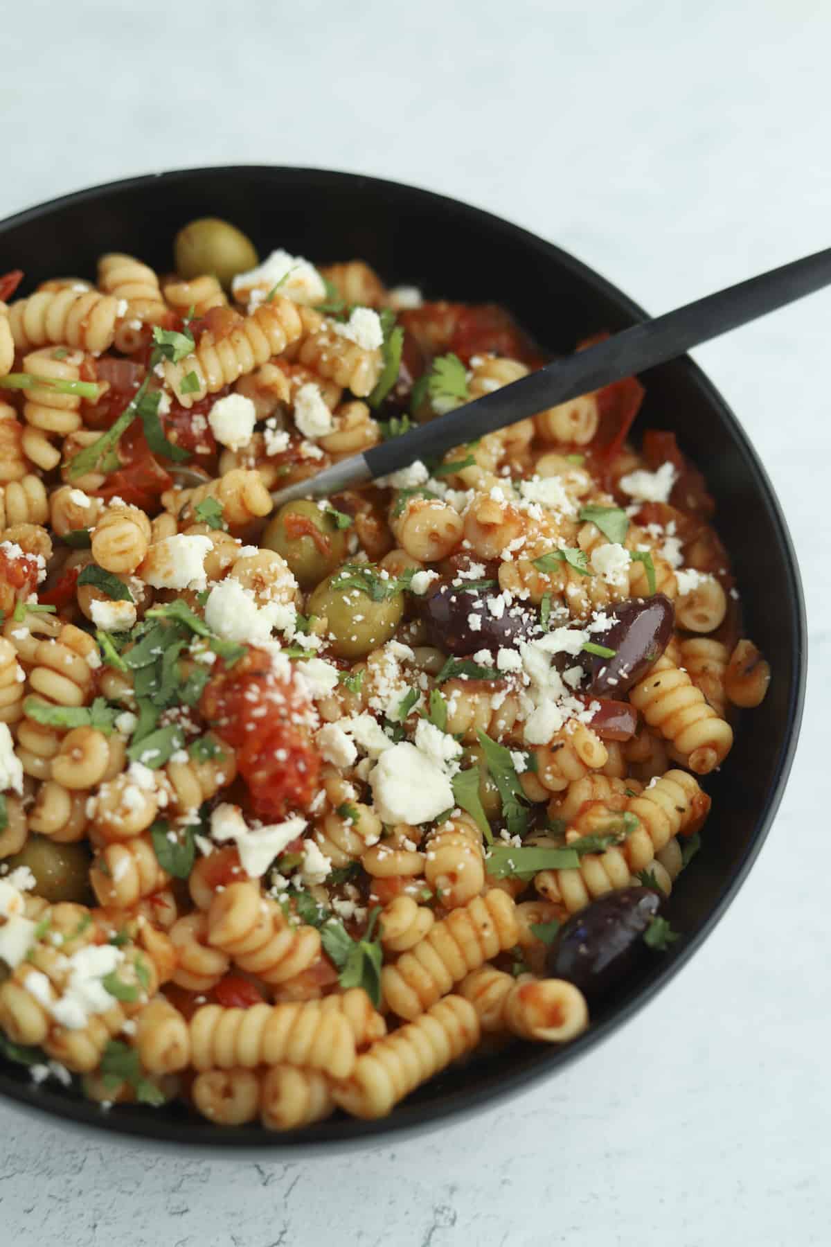 overhead plated greek pasta bake with a fork