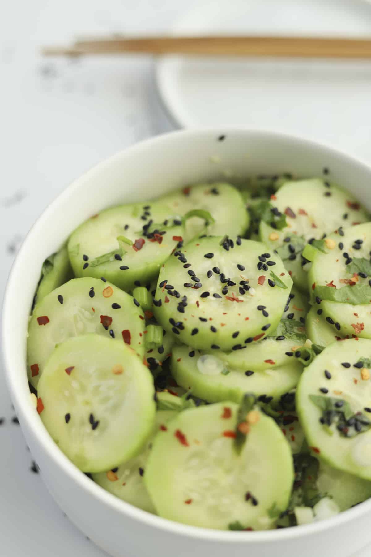 sideview of cucumbers with black sesame seeds. 