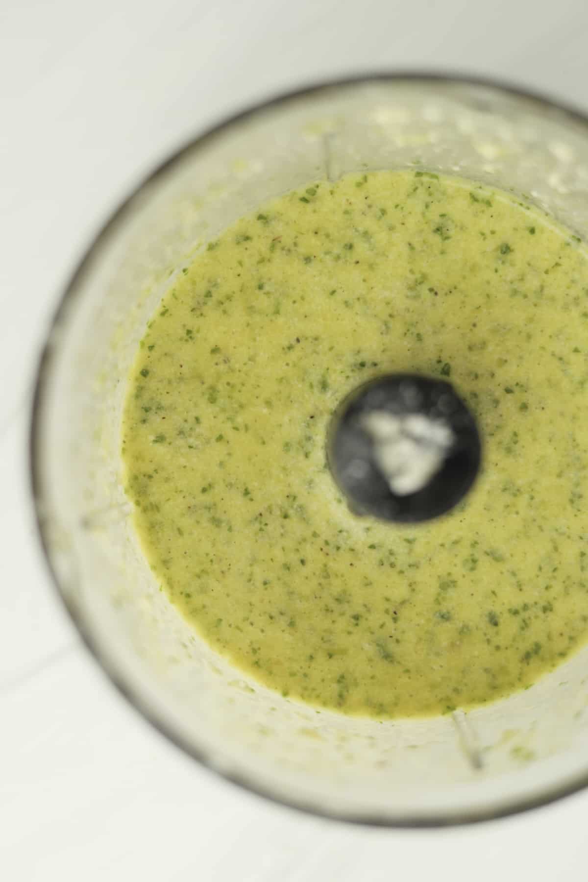 homemade salad dressing in the bowl of a food processor 