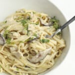 a bowl of one pot chicken tetrazzini with a fork sticking out