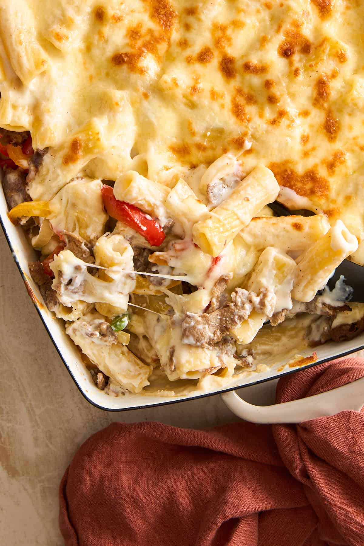 A Philly Cheesesteak Pasta bake with cheese and meat.