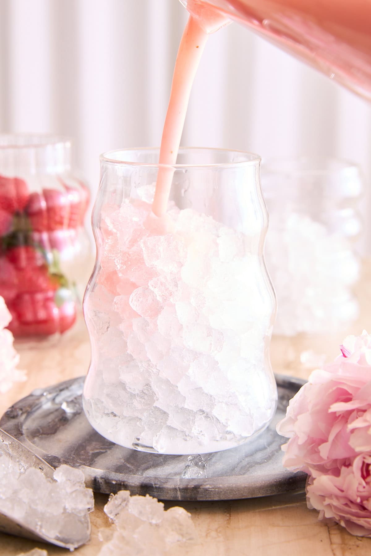 Pouring a pink drink in a glass