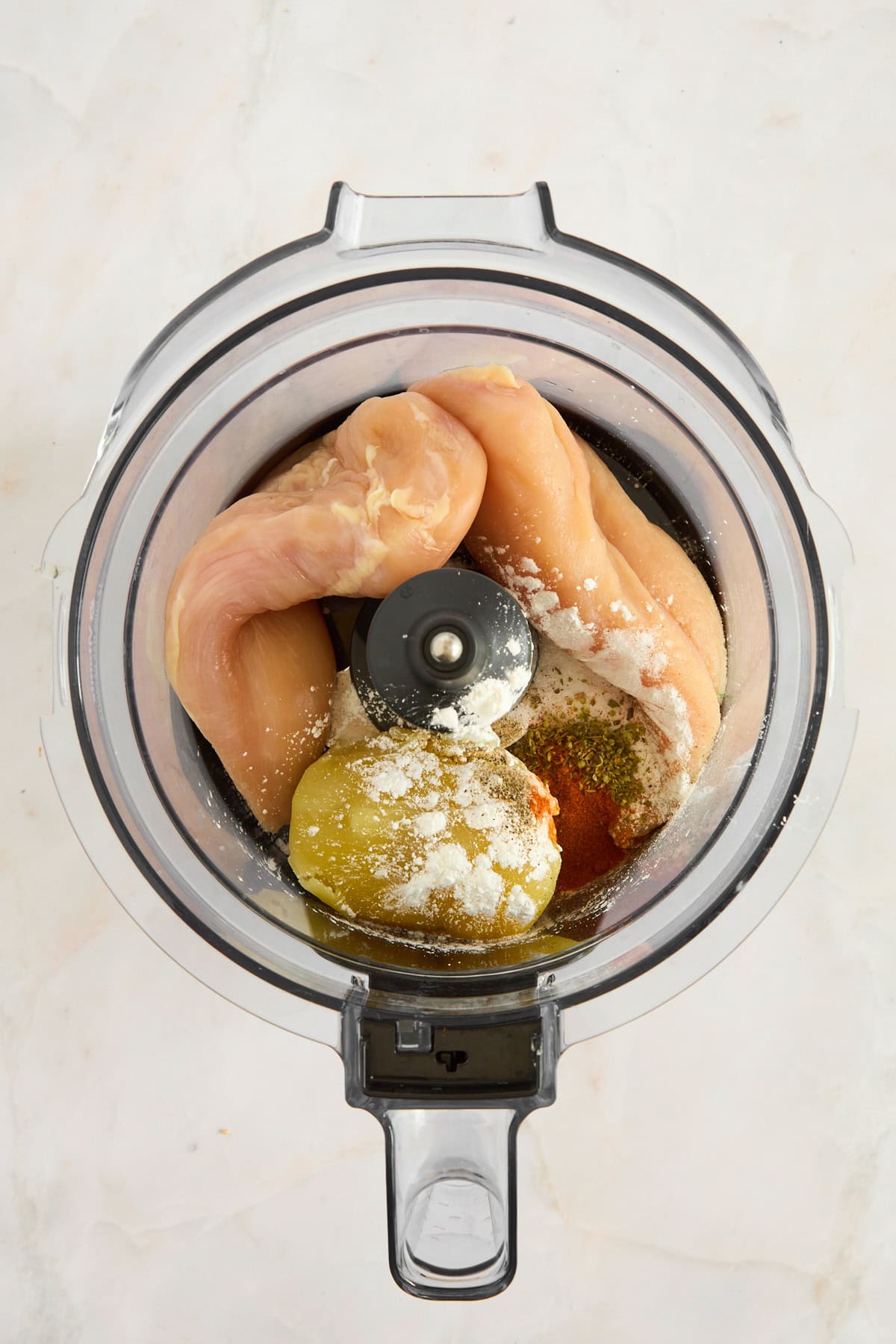 Ingredients to make chicken nuggets in a food processor. 