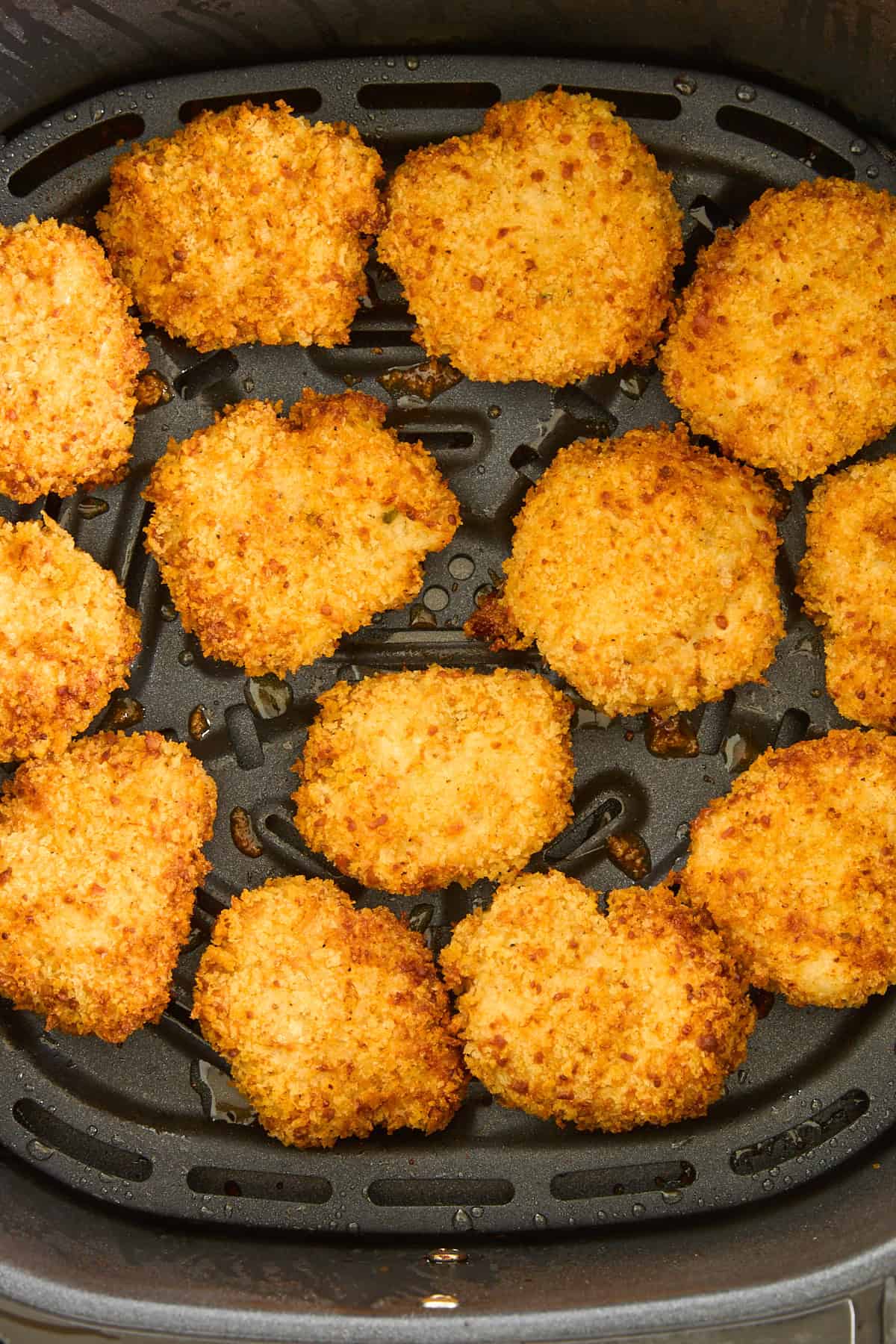 Cooked chicken nuggets in an air fryer. 