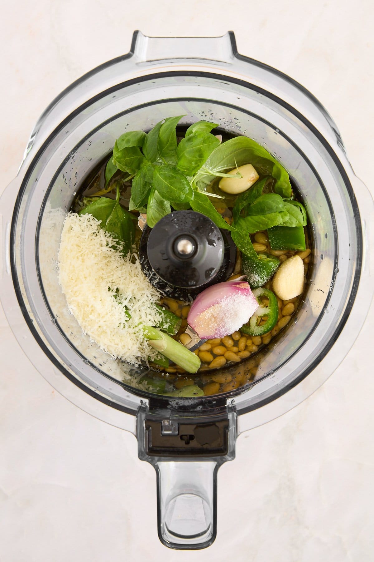 Green goddess dressing ingredients in a food processor. 