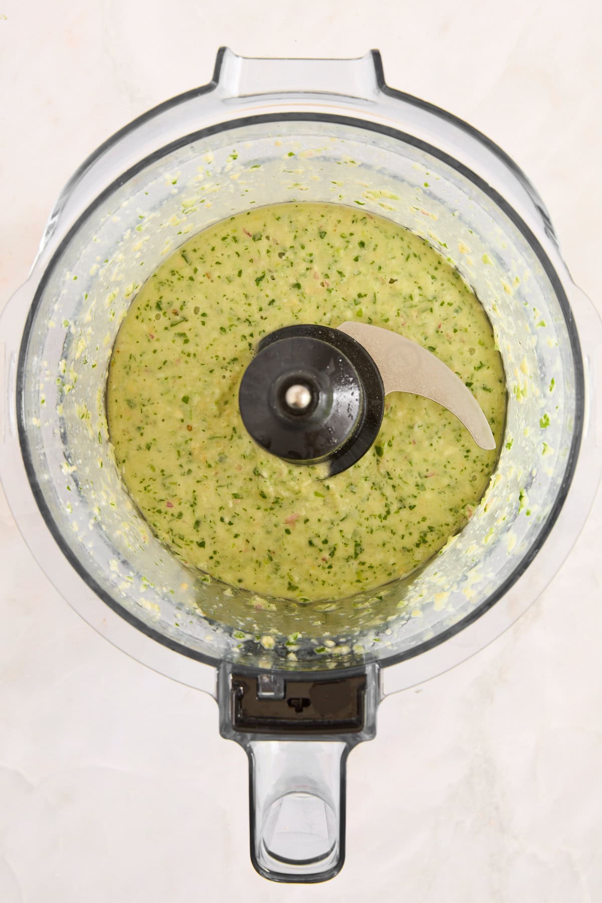 Green goddess dressing in a food processor. 