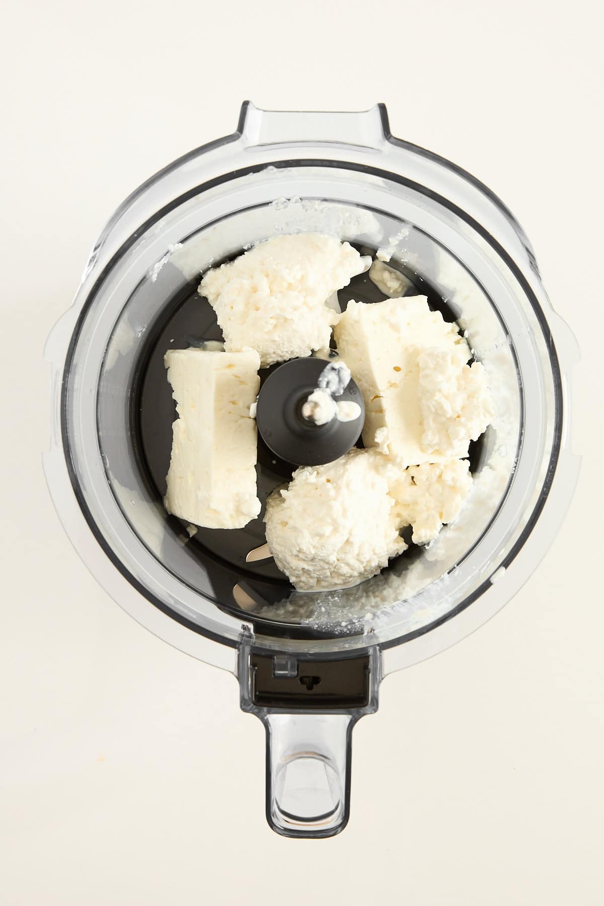 Whipped feta ingredients in a food processor.