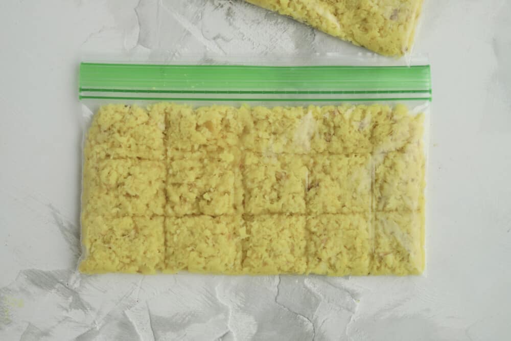 grated ginger in a ziploc bag portioned into 15 squares 
