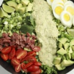 cobb salad topped with green goddess dressing