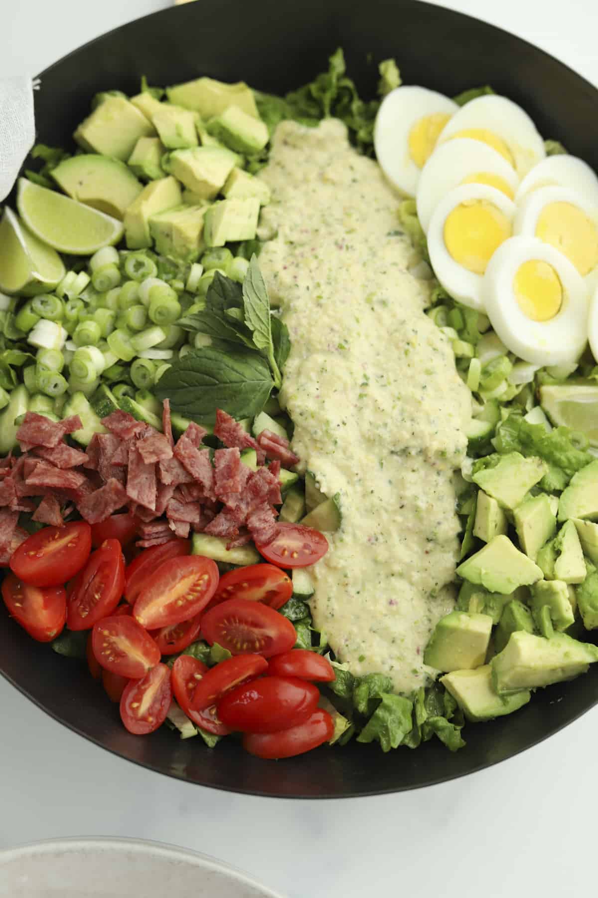 side view of cobb salad with green goddess salad