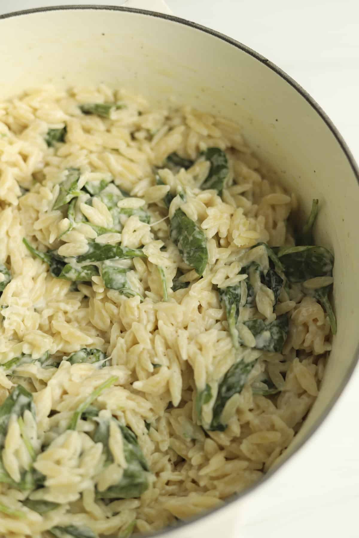 close up of creamy spinach orzo